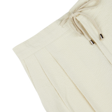 De Petrillo cream cotton seersucker drawstring trousers with pleat details.