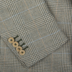 Close-up of a herringbone-patterned fabric with buttons on a De Petrillo Green Checked Wool Cotton Cashmere Posillipo Blazer sleeve.