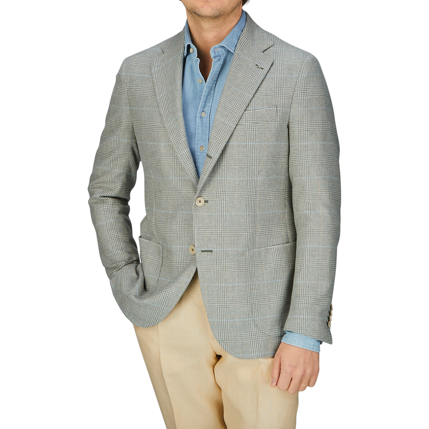 A man donning a De Petrillo Green Checked Wool Cotton Cashmere Posillipo Blazer over a light blue shirt, paired with beige trousers.