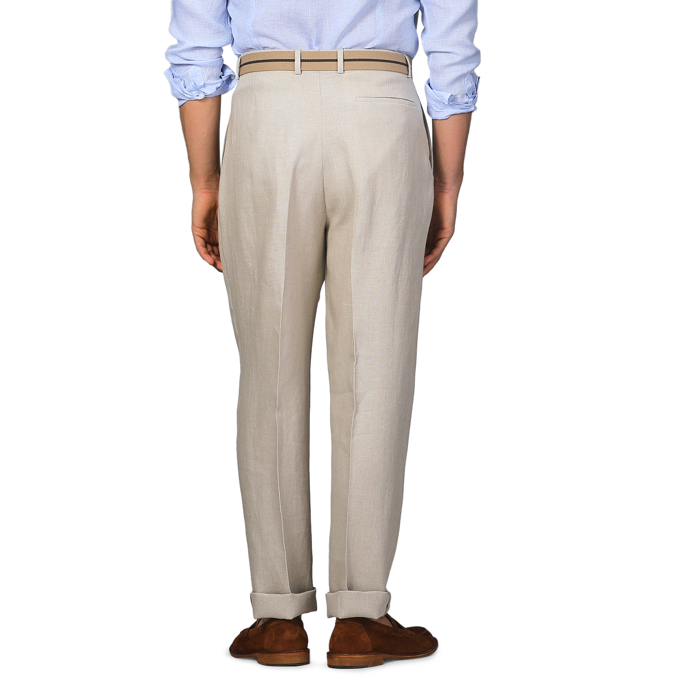 A person stands facing away wearing De Petrillo's Sand Beige Irish Linen Modello E Trousers, a light blue shirt, and brown shoes.