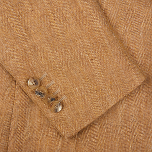 Close-up of a De Petrillo Tobacco Brown Herringbone Pure Linen Suit with a row of buttons.