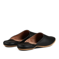 A pair of black, handmade leather slip-on shoes with a tan interior, displayed on a black background. 

Replace with: A pair of Derek Rose Black Leather Sheepskin Open Slippers with a tan interior displayed on a black background.