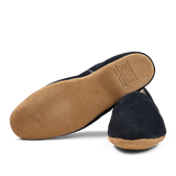 A pair of Navy Suede Sheepskin Closed-Back Slippers by Derek Rose with a soft sole displayed on a black background.