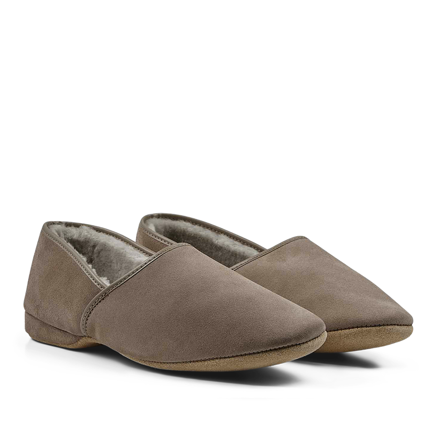 A pair of Derek Rose Taupe Suede Sheepskin Closed-Back Slippers with a fluffy sheepskin lining.