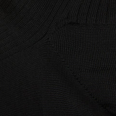 Close-up view of a black Doré Doré Cotton Fil d'Ècosse Ribbed Socks, showing detailed weave pattern with varying textures and stitch styles.