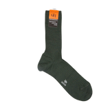 A pair of hardwearing Thuya Green Merino Wool Ribbed Socks made by Doré Doré, with an orange label.