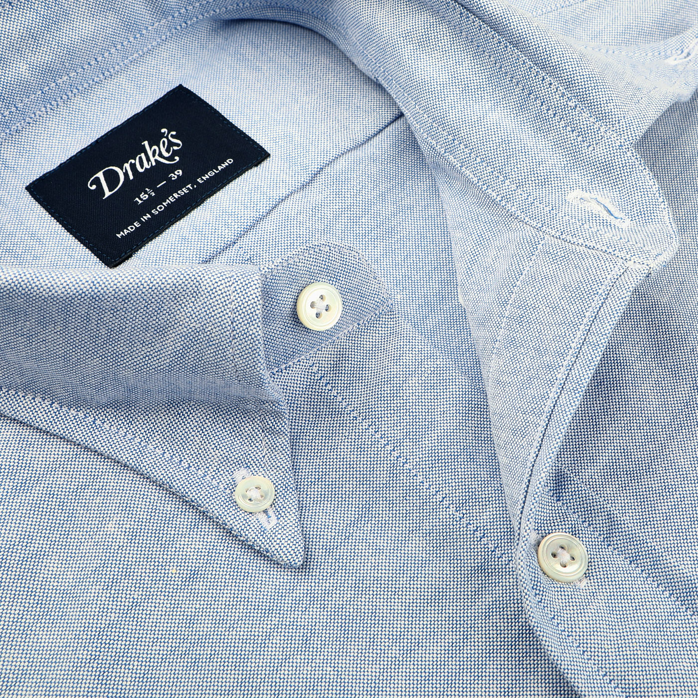 Close-up of a Drake's Blue Classic Cotton Oxford BD Shirt, featuring white buttons and proudly showcasing its British craftsmanship from Somerset, England.