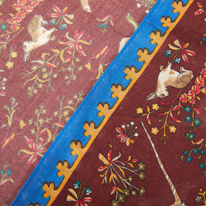 A close up of a Drake's Burgundy Blue Wool Silk Unicorn Print Scarf with animals on it.