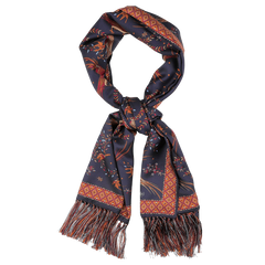 A navy silk scarf from Drake's, known as the "Navy Birds of Paradise Print Tubular Silk Scarf," displays intricate patterns in red and orange, complete with fringe at the ends.