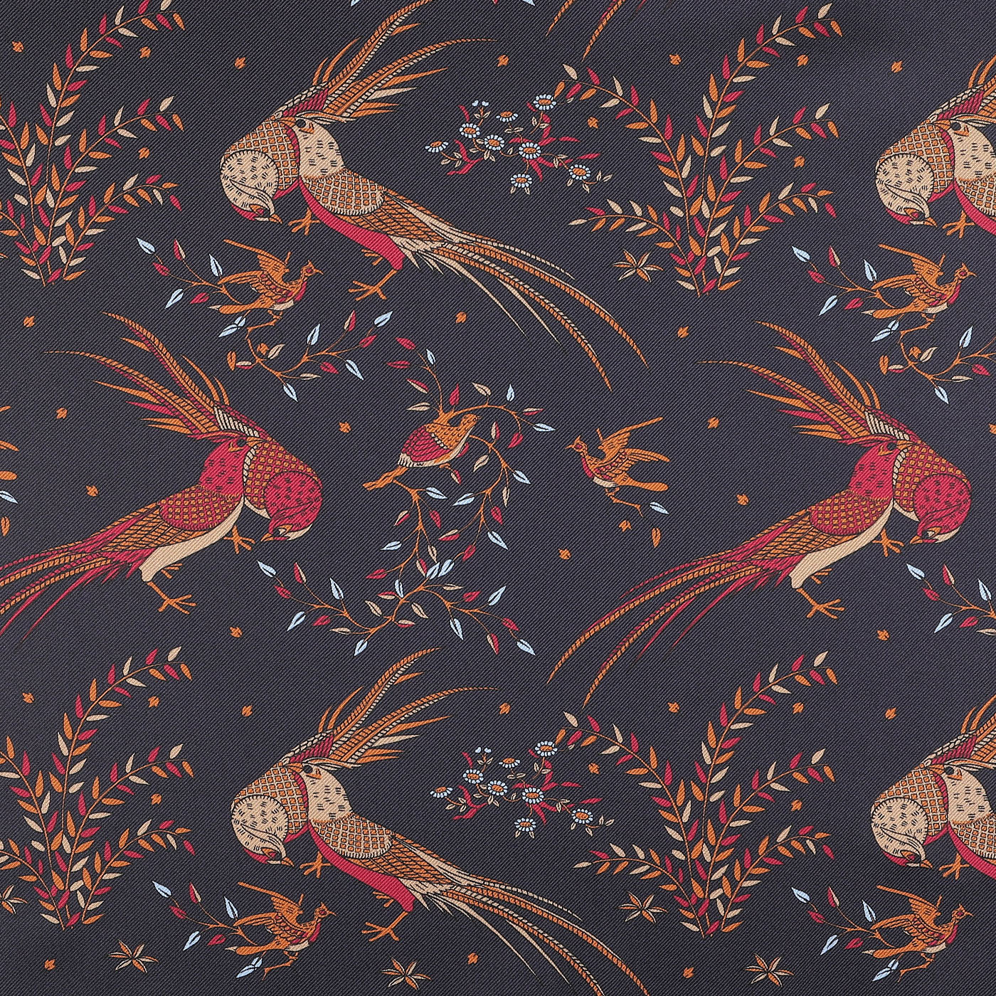 Introducing the Drake's Navy Birds of Paradise Print Tubular Silk Scarf, featuring a patterned fabric adorned with illustrated birds and floral motifs in vibrant red, orange, and blue against a dark backdrop, epitomizing the elegant style reminiscent of Como, Italy.