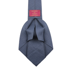 A cobalt blue handmade "Dreaming Of Monday" Bleu Cézanne 7-Fold French Linen Tie is displayed against a plain background, highlighting its unlined 7-fold construction.