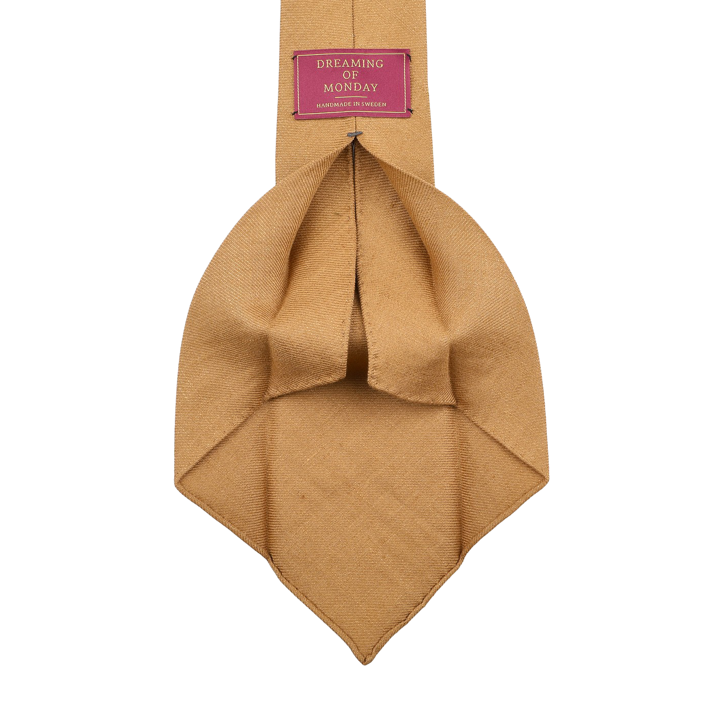 The Château Noir Ochre 7-Fold French Linen Tie by Dreaming Of Monday boasts a beige texture with a red label stating "Dreaming of Monday" and "Handmade in Italy," offering artisanal charm to elevate your wardrobe.