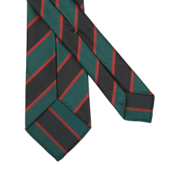 Two Green Black Regimental 7-Fold Wool Ties by Dreaming Of Monday, featuring green, red, and black diagonal stripes, lying overlapping on a white background.