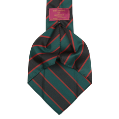 A skinny neck tie with a striped pattern in shades of green and red, handmade from a lightweight wool mix. The Green Black Regimental 7-Fold Wool Tie by Dreaming Of Monday.