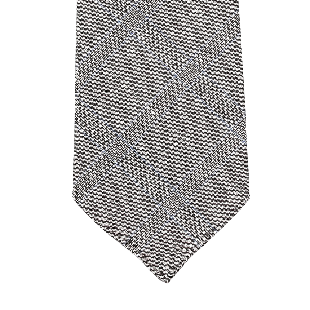 Close-up of the Grey Blue Glen Plaid 7-Fold Vintage Wool Tie by Dreaming Of Monday, featuring a plaid pattern in gray and blue. This handmade tie from Sweden is crafted from pure wool and set against a white background.