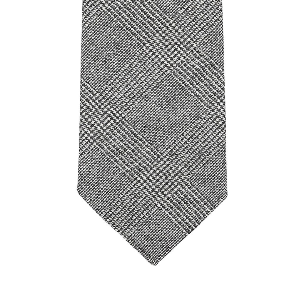 Explore the sophistication of our Grey Glen-Checked 7-Fold Wool Flannel Tie by Dreaming Of Monday, showcasing a gray checkered pattern with diagonal lines on a white background. Made from premium Super 120s wool flannel, this tie features an unlined 7-fold construction for an elegant and luxurious look.