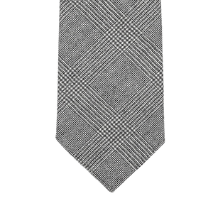 Explore the sophistication of our Grey Glen-Checked 7-Fold Wool Flannel Tie by Dreaming Of Monday, showcasing a gray checkered pattern with diagonal lines on a white background. Made from premium Super 120s wool flannel, this tie features an unlined 7-fold construction for an elegant and luxurious look.