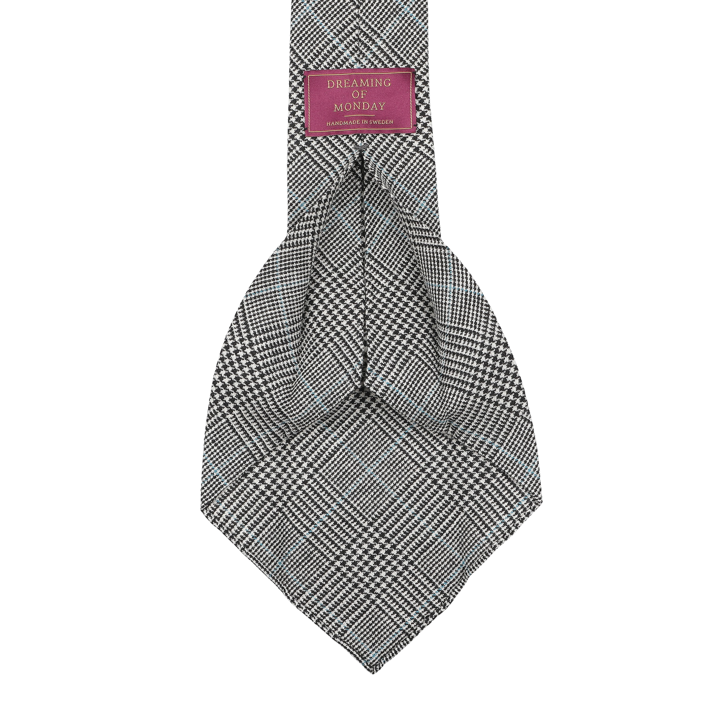 The Grey Prince of Wales 7-Fold tie, crafted in Sweden from vintage wool, has a burgundy label that says "Dreaming Of Monday.