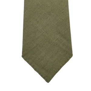 The Jardin Provençal Green 7-Fold French Linen Tie by Dreaming Of Monday is handmade with a textured olive hue and has a classic pointed tip.