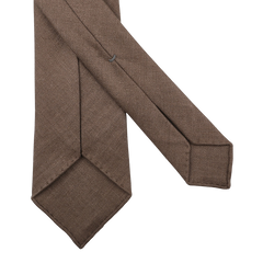 The Marronniers Brown 7-Fold French Linen Tie by Dreaming Of Monday is elegantly showcased, displaying both front and back against a crisp white background.