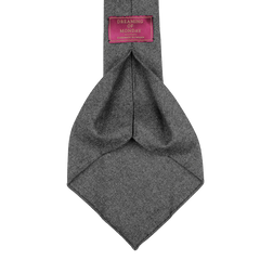 Mid Grey 7-Fold Wool Flannel Tie, crafted by Dreaming Of Monday, with a visible brand label attached to the back side.