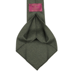 A luxurious wool flannel tie in moss green, made by Dreaming of Monday, includes a tag that says "Handmade in Sweden.