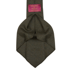 A green tweed necktie with a pink label, handmade with Moss Green Loro Piana Wool Cashmere fabric.