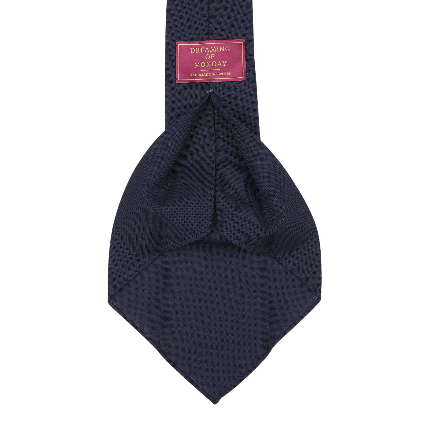 A Navy Blue Wool Fresco 7-Fold Tie labeled "Dreaming Of Monday," crafted with a luxurious pure high-twist wool and featuring an elegant 7-fold construction, displayed against a plain white background.