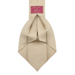 The Rocher Rouge Beige 7-Fold French Linen Tie by Dreaming Of Monday features a red label with "Dreaming of Monday" in crisp white text.