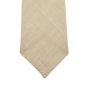 Close-up of the Rocher Rouge Beige 7-Fold French Linen Tie by Dreaming Of Monday on a white background.