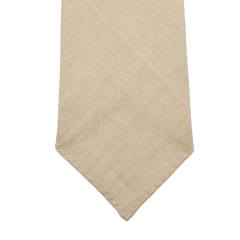 Close-up of the Rocher Rouge Beige 7-Fold French Linen Tie by Dreaming Of Monday on a white background.