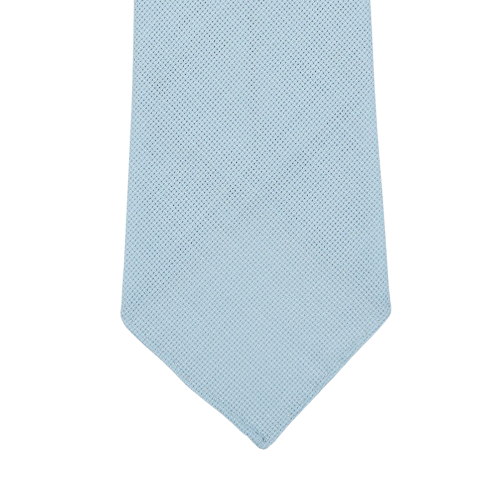 Close-up of the end section of a Sky Blue 7-Fold Wool Hopsack Tie by Dreaming Of Monday, displayed against a white background.