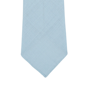 Close-up of the end section of a Sky Blue 7-Fold Wool Hopsack Tie by Dreaming Of Monday, displayed against a white background.