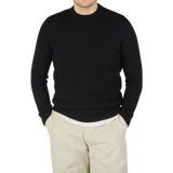 A man wearing a Drumohr Black Brushed Lambswool High Neck Sweater.