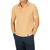Man wearing a Drumohr Cappuccino Beige Cotton Piquet polo shirt and navy trousers.