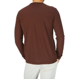 The man is wearing a long-sleeve shirt from Drumohr, specifically the Golden Brown Ice Cotton LS T-Shirt.