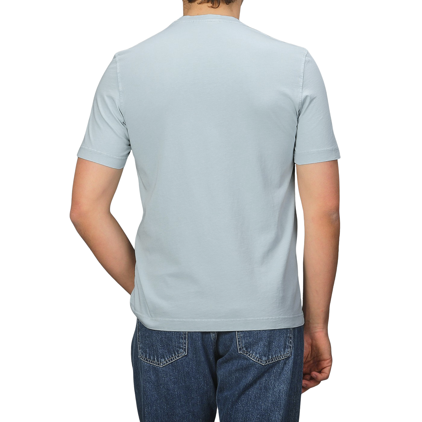 A person in a Drumohr Sky Blue Washed Cotton T-Shirt and blue jeans stands with their back to the camera, highlighting the slim fit design.