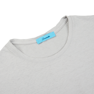 A close up of a Light Grey Cotton Linen T-Shirt with a blue label from Drumohr in Italy.