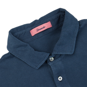A slim fit medium blue Drumohr cotton piquet LS polo shirt with a pink label on the collar.