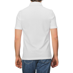 A person in a Drumohr Off-White Cotton Pique Polo Shirt and blue jeans is shown from the back against a plain background.