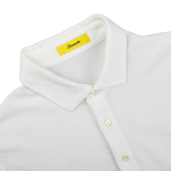 The Drumohr Off-White Cotton Pique Polo Shirt features a slim fit with a yellow label near the collar, crafted from soft cotton pique and laid flat against a light background.