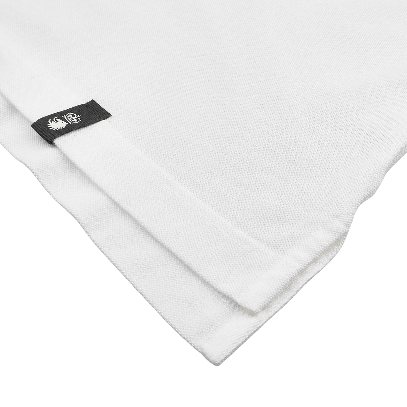 Close-up of a folded Drumohr Off-White Cotton Pique Polo Shirt with a black logo tag in the corner, showcasing its refined texture.