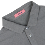 Close-up of a Drumohr steel grey cotton linen polo shirt collar with a brand label and button detail.