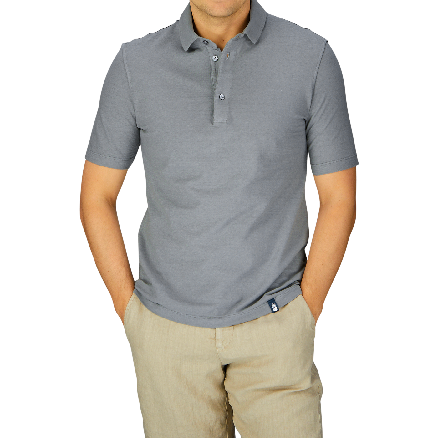 Man wearing a Drumohr steel grey cotton linen polo shirt and beige pants against a gray background.