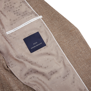 A close up of a Brown Herringbone Cotton Blend Sendrik Blazer with a label bearing the name Eduard Dressler.