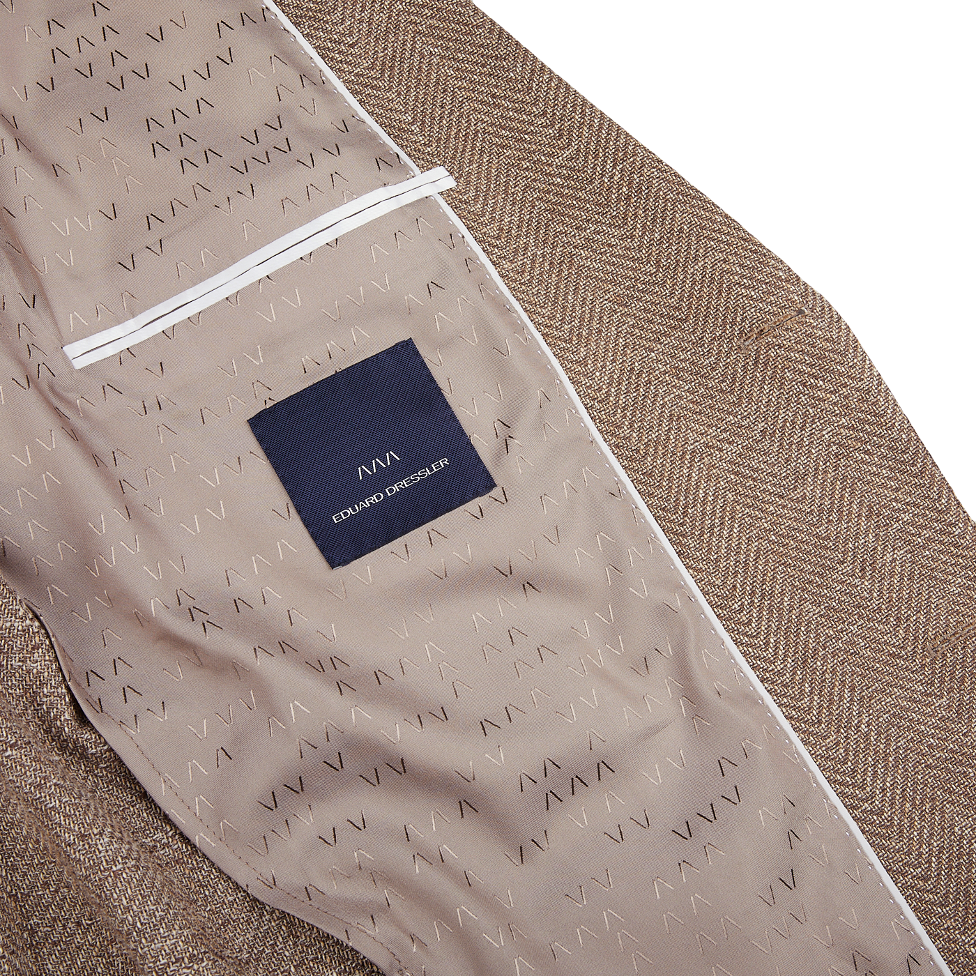 A close up of a Brown Herringbone Cotton Blend Sendrik Blazer with a label bearing the name Eduard Dressler.
