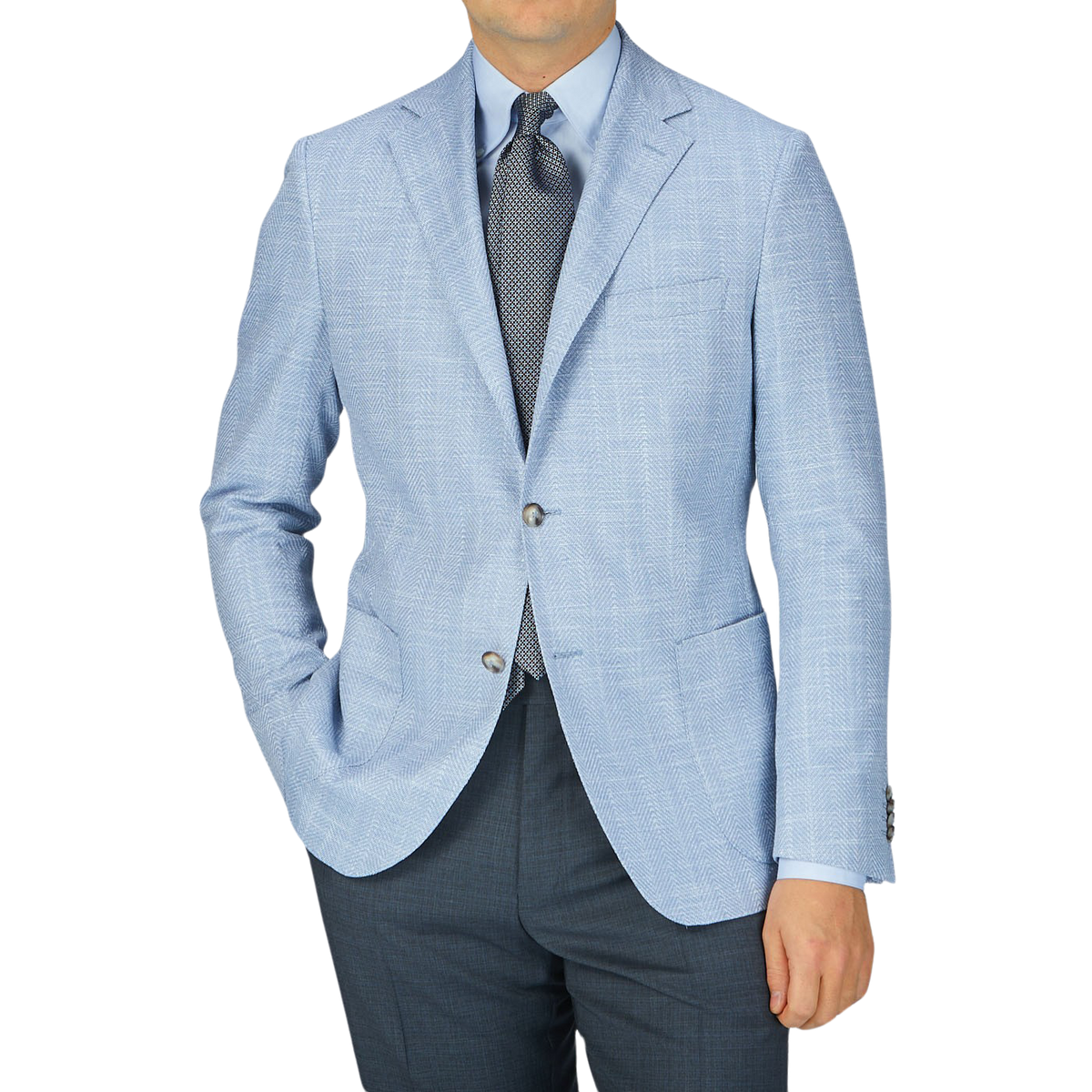 A man wearing an Eduard Dressler Light Blue Herringbone Cotton Linen Sendrik Blazer.