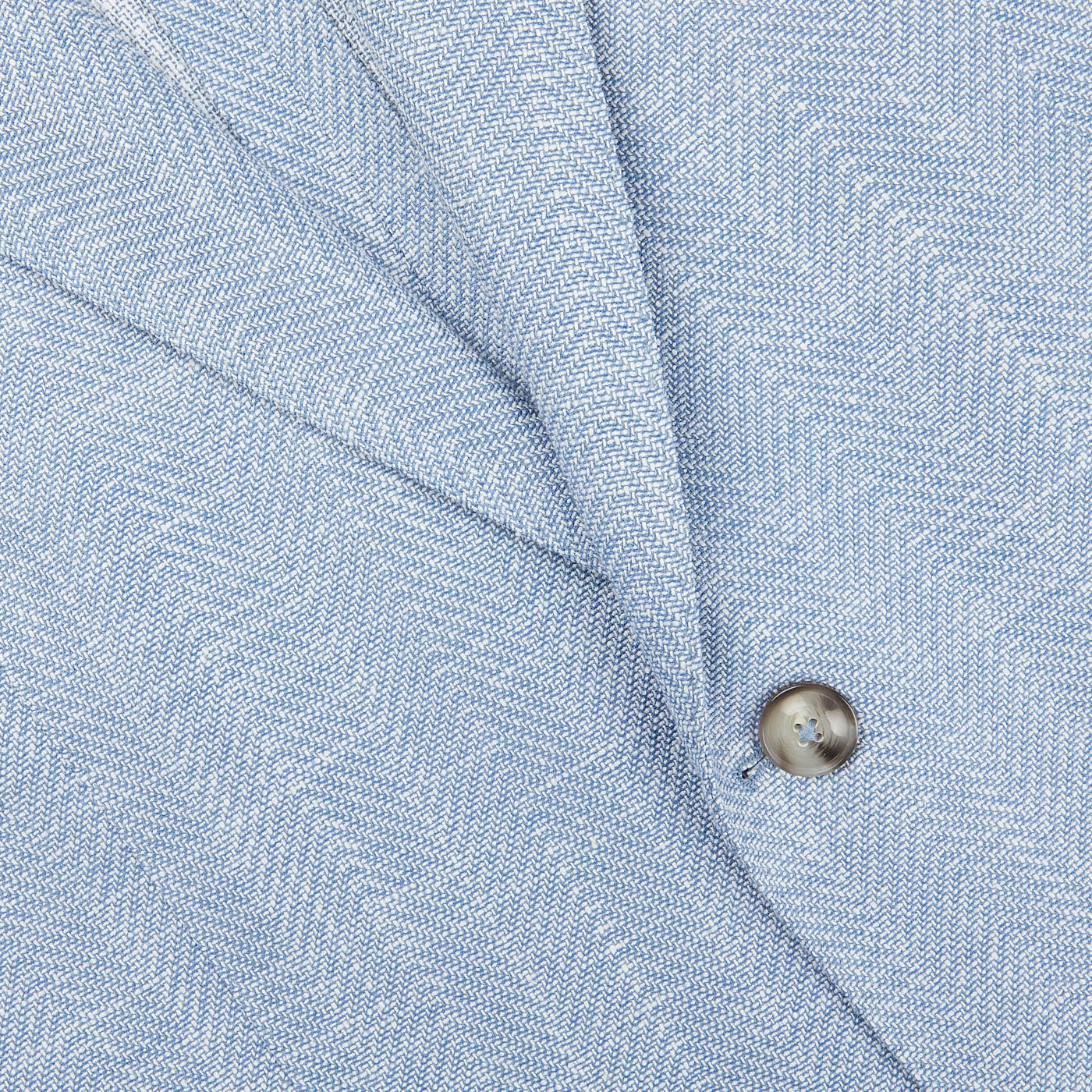 A close up image of an Eduard Dressler Light Blue Herringbone Cotton Linen Sendrik Blazer.
