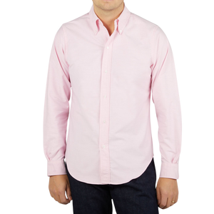 A man wearing a Far East Manufacturing Pink Cotton Oxford BD Regular Shirt.