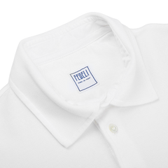 A Fedeli washed white cotton pique polo shirt for the summer wardrobe.